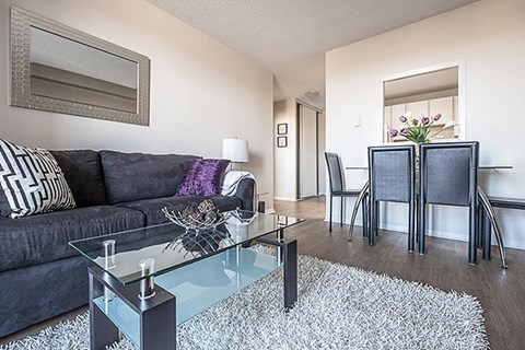 a living room with a couch and a glass table